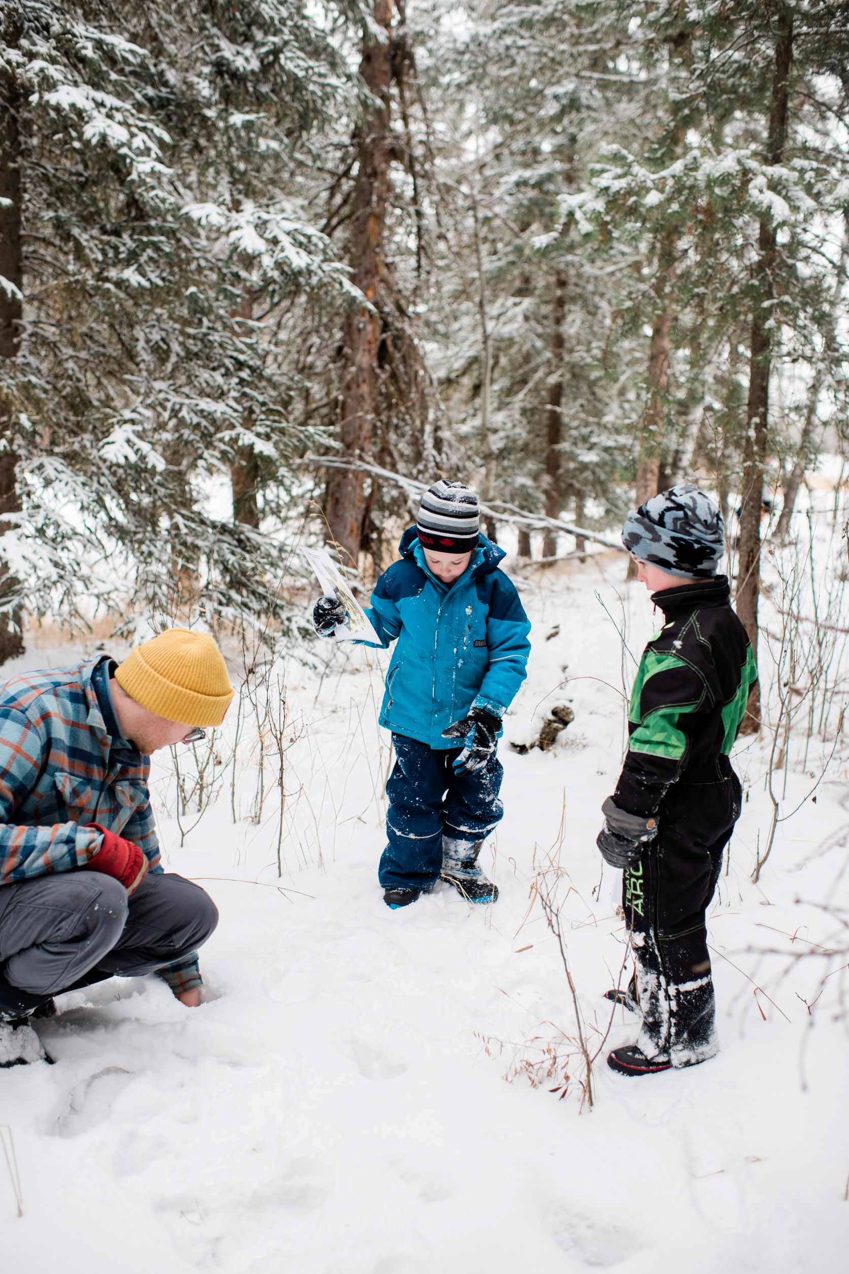 kids learning to identify animal tracks in the snow