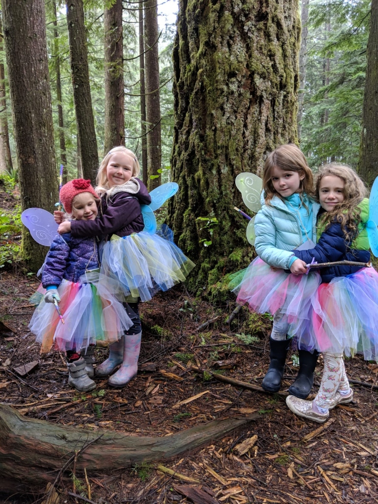 Girls dressed as fairies in the woods for a birthday party