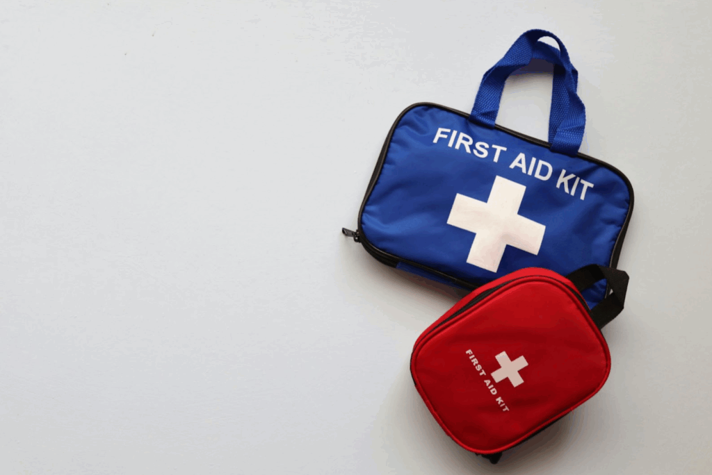 two first aid kits, one bigger and one smaller, on a white surface, highlighting outdoor safety when hiking with kids