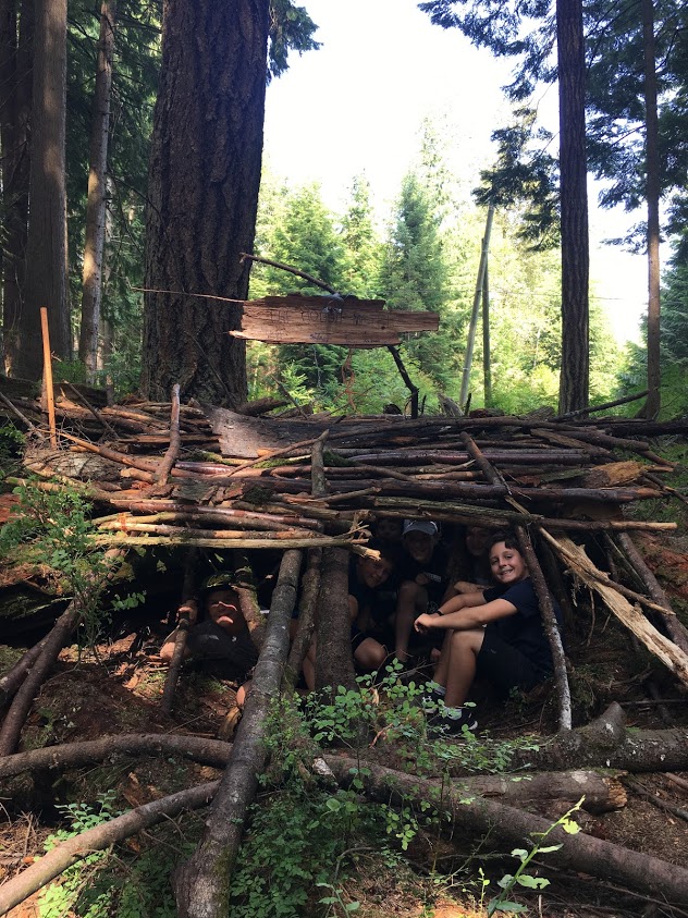 Group of kids making wilderness shelter