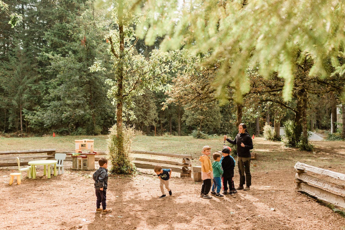 Group of young kids lining up at forest school