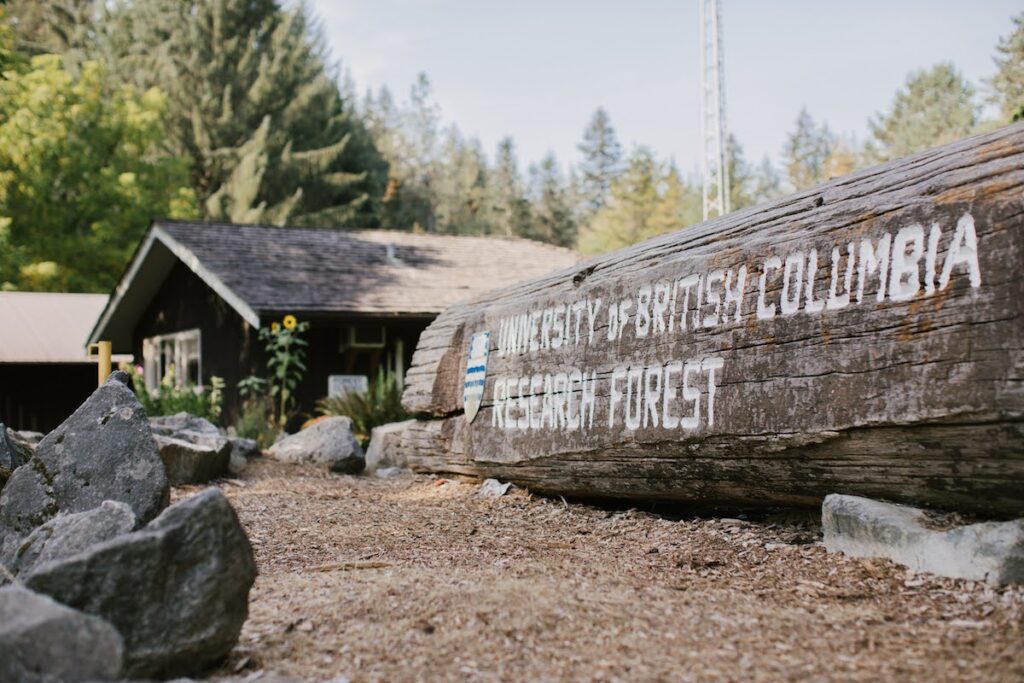 University of British Columbia Research Forest sign on large fallen log at Malcolm Knapp Research Forest