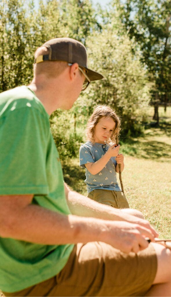 Young kid carving stick at williams lake outdoor education school in 2020