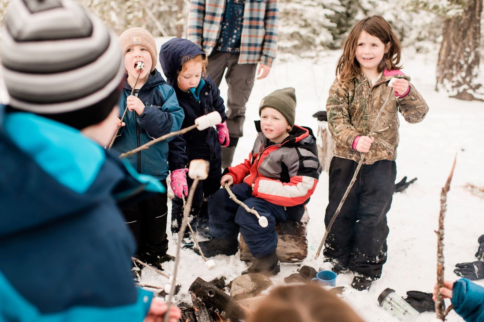 five young kids roasting marshmallows at the wild and immersive outdoor learning program in williams lake
